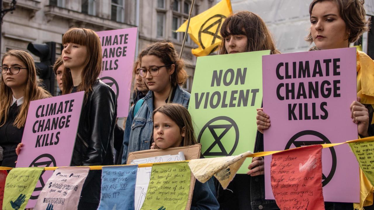 A scene from the XR (Extinction Rebellion) protest, "Blood of our Children," March 9, 2019, Downing Street, London, UK. During this protest, protesters threw hundreds of gallons of fake blood into the middle of Downing Street. [Photo: Miriam Hauertmann]