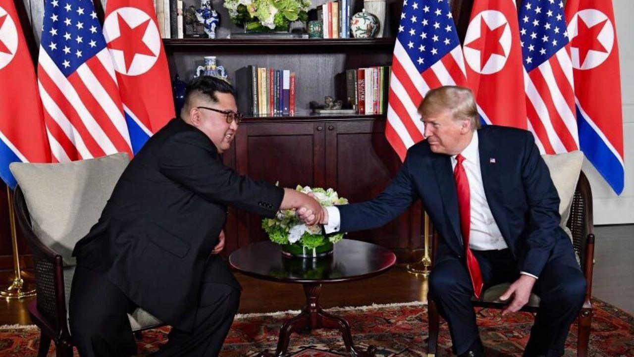 Presidents Trump and Kim shaking hands in the summit room during the 2018 Singapore Summit. June, 2018