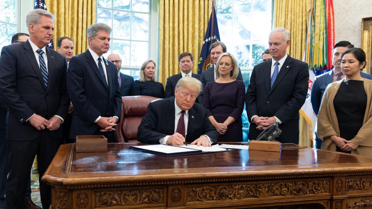 President Donald J. Trump signs the Cybersecurity and Infrastructure Security Agency Act Friday, Nov. 16, 2018, in the Oval Office of the White House. (Official White House Photo by Joyce N. Boghosian)