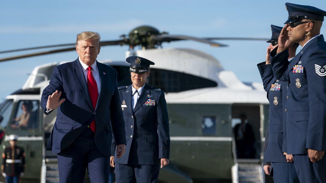 President Donald J. Trump disembarks Marine One at Joint Base Andrews, Md. and is escorted by U.S. Air Force Col. Kimberly Welter Vice Commander of the 89th Airlift Wing Thursday, Oct. 10, 2019. (Official White House Photo by Tia Dufour)