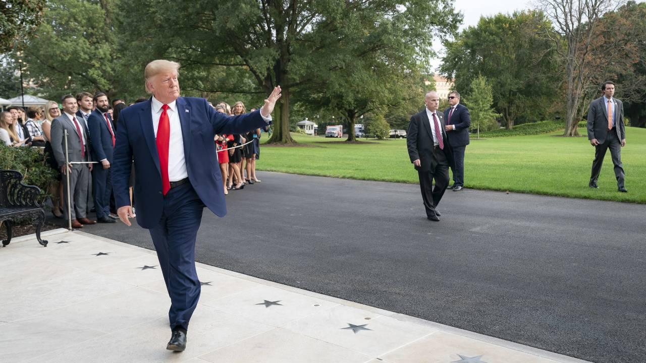 President Donald J. Trump waves after stopping to speak with White House visitors and staff members following his arrival back to the White House Thursday, Oct. 3, 2019, following his visit to The Villages, FL. (Official White House Photo by Tia Dufour)