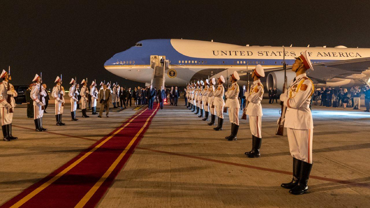 President Donald J. Trump, escorted by Mai Phuoc Dung, Director General of State Protocol of the Socialist Republic of Vietnam, walks along a red carpet from Air Force One and reviews an Honor Cordon upon his arrival Tuesday, Feb. 26, 2019, in Hanoi.