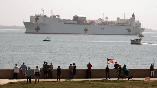 NORFOLK (March 28, 2020) People gather to watch the Military Sealift Command hospital ship USNS Comfort (T-AH 20) depart Naval Station Norfolk, Va., March 28, 2020. (US Navy photo by Mass Communication Specialist 1st Class Joshua D. Sheppard/Released)